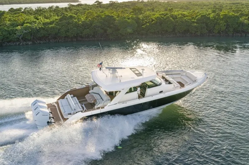 Slide: The Image of 2023 Tiara Yachts 48 LS cruising on a scenic waterway. - 7