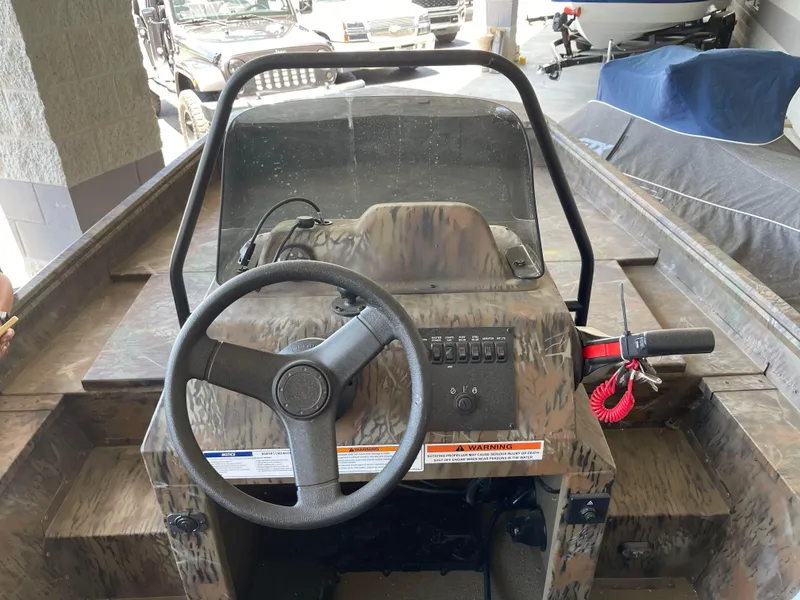 Slide: The Image of 2024 G3 Gator Tough 17 CCJ boat console with steering wheel and controls. - 10