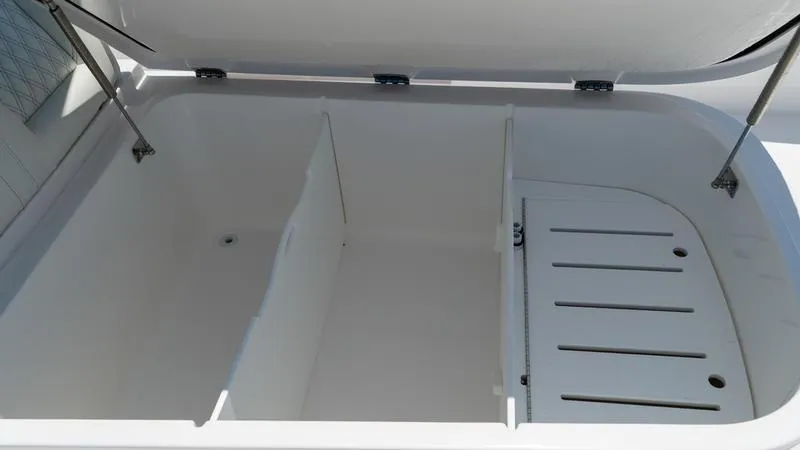 Slide: The Image of Open storage compartment of 2024 Invincible 40' Catamaran with dividers and drainage. - 13