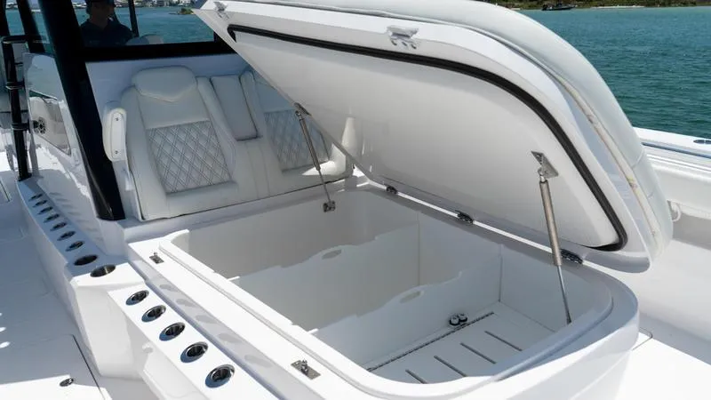 Slide: The Image of 2024 Invincible 40' Catamaran with open storage compartment and luxury seating. - 14