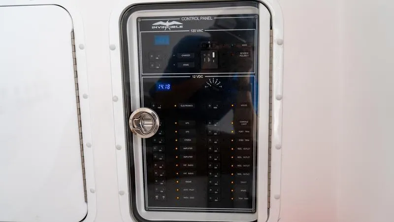 Slide: The Image of Control panel of 2024 Invincible 40' Catamaran with 12V and 120V switches. - 16
