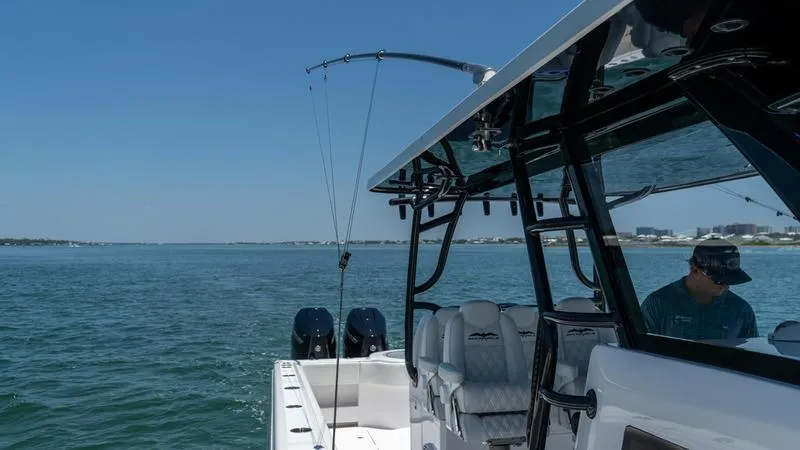 Slide: The Image of 2024 Invincible 40' Catamaran on open water with fishing gear. - 20