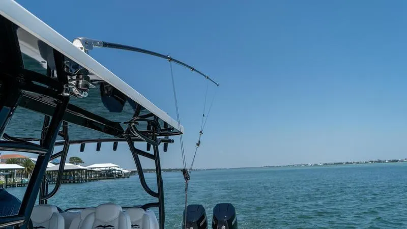 Slide: The Image of 2024 Invincible 40' Catamaran on water with fishing rods and outboard motors. - 22