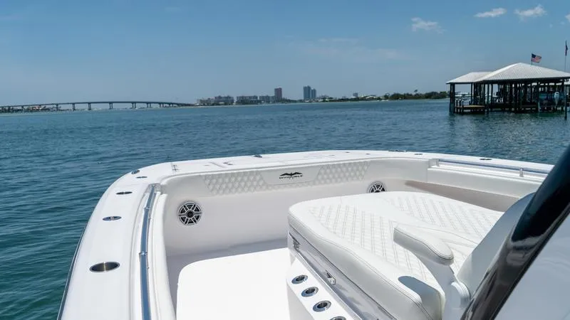 Slide: The Image of 2024 Invincible 40' Catamaran on calm waters with city skyline in the background. - 23