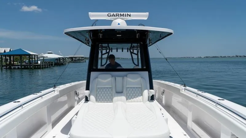 Slide: The Image of 2024 Invincible 40' Catamaran on calm waters with Garmin navigation system. - 25