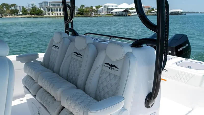 Slide: The Image of Luxurious seating on the 2024 Invincible 40' Catamaran, with scenic waterfront backdrop. - 26