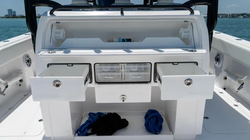 Slide: The Image of 2024 Invincible 40' Catamaran with open storage compartments and drawers on deck. - 30