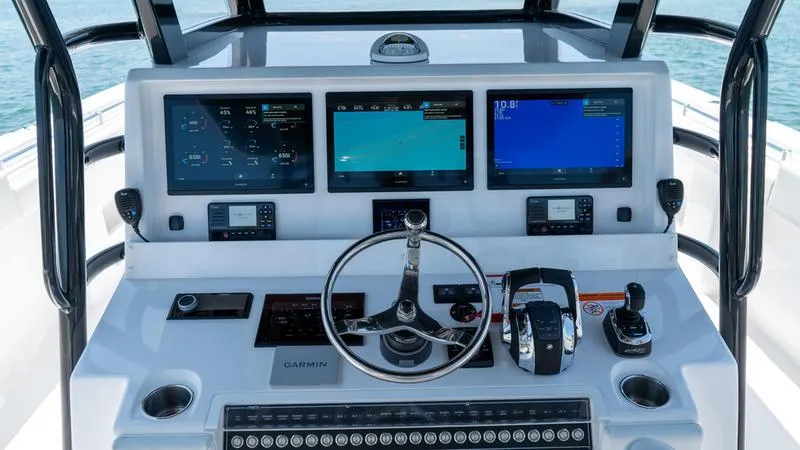 Slide: The Image of 2024 Invincible 40' Catamaran helm with advanced navigation systems and controls. - 31