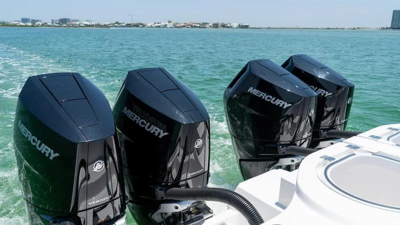 Slide: The Image of 2024 Invincible 40' Catamaran with four Mercury outboard engines on the water. - 35