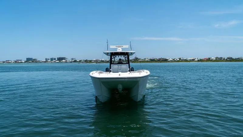 Slide: The Image of 2024 Invincible 40' Catamaran on calm waters with cityscape in the background. - 5