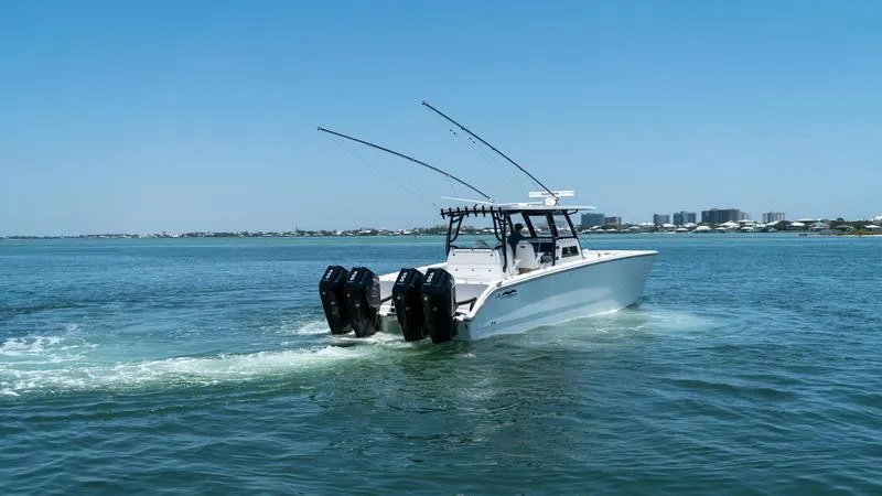 Slide: The Image of 2024 Invincible 40' Catamaran cruising on open water with twin outboard engines. - 9