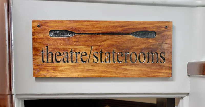 Slide: The Image of Wooden sign reading "theatre/staterooms" on a 1945 custom motor yacht. - 17