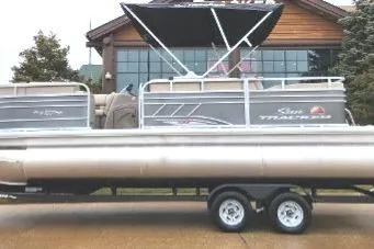The Image of 2023 Sun Tracker Party Barge 22 RF XP3 pontoon boat on trailer, parked outdoors. - 0