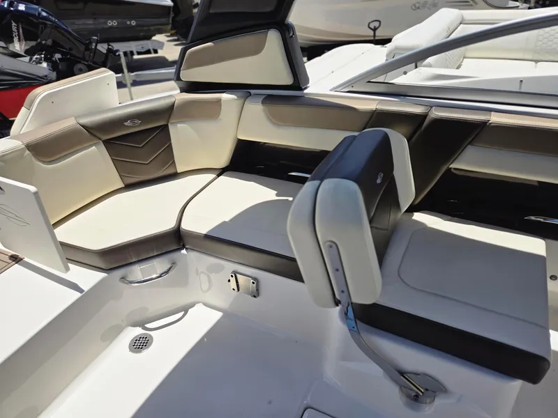 Slide: The Image of 2021 Chaparral 230 boat interior with white and black seating. - 10