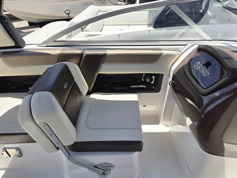 Slide: The Image of Interior of a 2021 Chaparral 230 boat with seating and dashboard. - 11