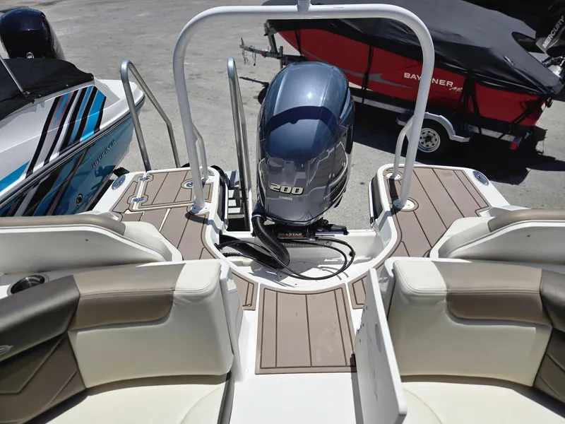 Slide: The Image of 2021 Chaparral 230 boat with Yamaha 200 outboard motor, rear seating and swim platform. - 12