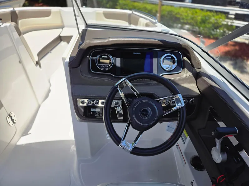 Slide: The Image of 2021 Chaparral 230 boat dashboard with steering wheel and control panel. - 3