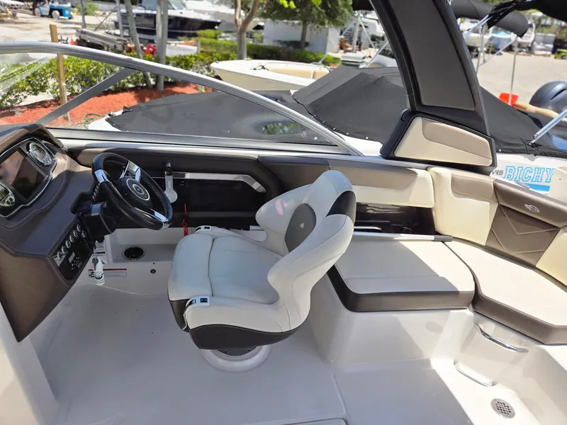 Slide: The Image of 2021 Chaparral 230 boat interior with captain's chair and dashboard. - 8
