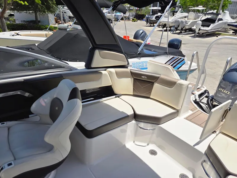 Slide: The Image of 2021 Chaparral 230 boat interior with seating and helm station. - 9