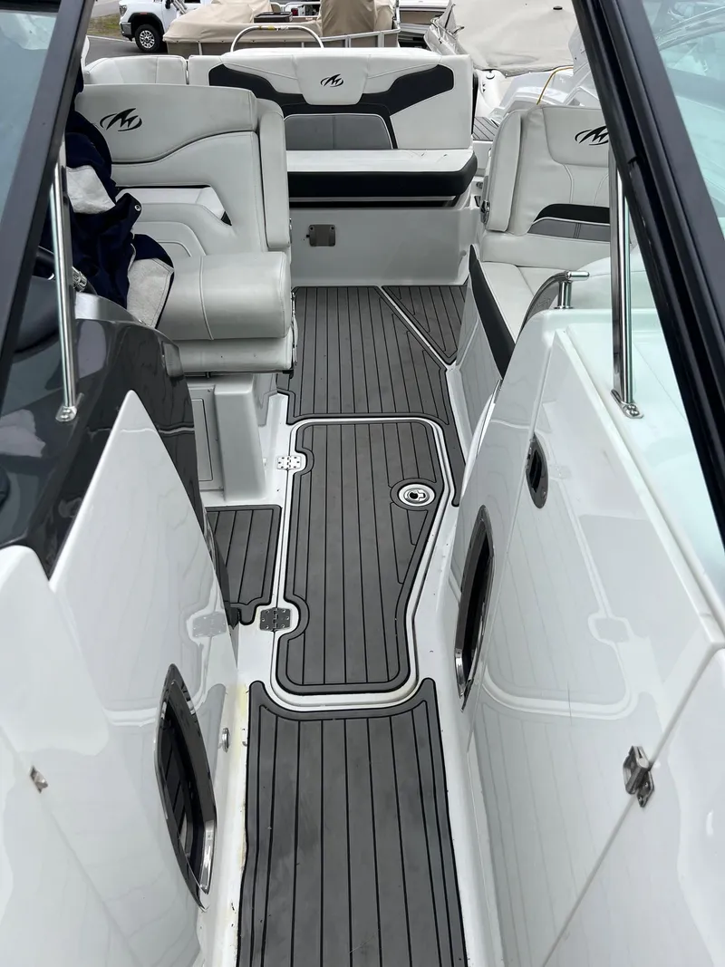 Slide: The Image of 2016 Monterey 328SS boat interior with gray flooring and white seating. - 12