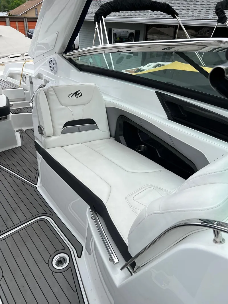 Slide: The Image of 2016 Monterey 328SS boat with white leather seating and sleek design. - 13