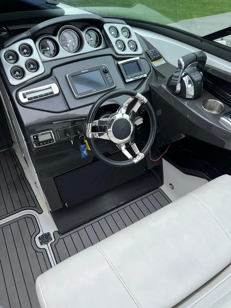 Slide: The Image of Cockpit of a 2016 Monterey 328SS boat with modern controls and steering wheel. - 18
