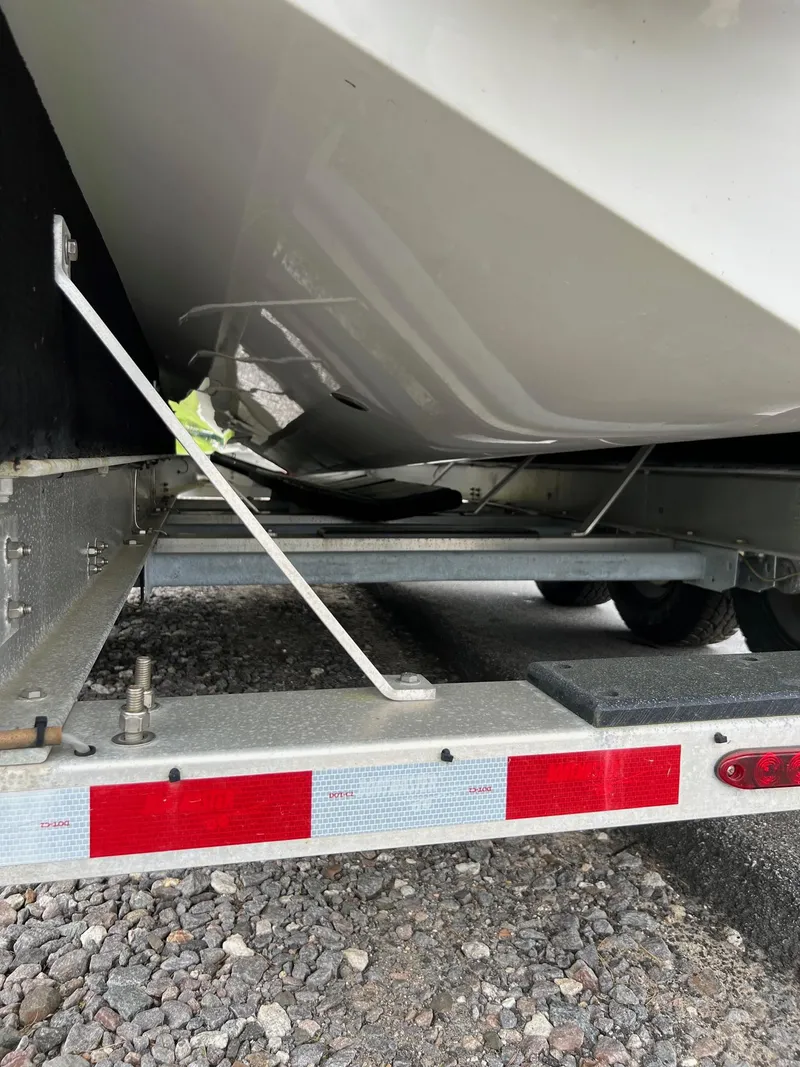 Slide: The Image of 2016 Monterey 328SS boat on a trailer, close-up view of the hull and trailer frame. - 27