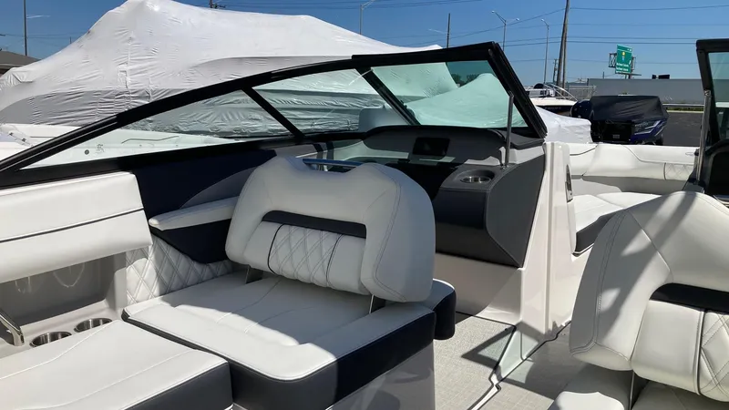 Slide: The Image of 2024 Regal LS2 boat interior with white and black seating, windshield, and dashboard. - 5