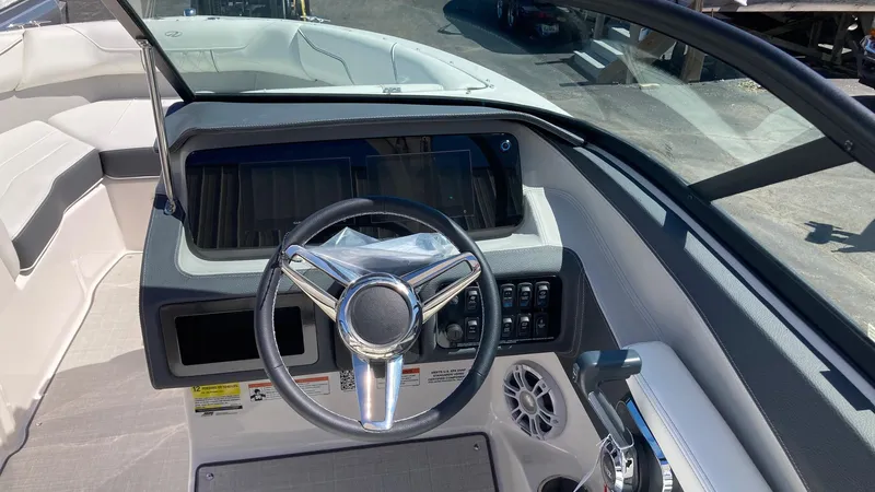 Slide: The Image of 2024 Regal LS2 boat dashboard with steering wheel and control panel. - 6