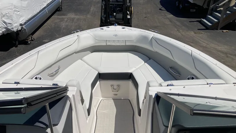 Slide: The Image of 2024 Regal LS2 boat interior with white seating and open bow design. - 7