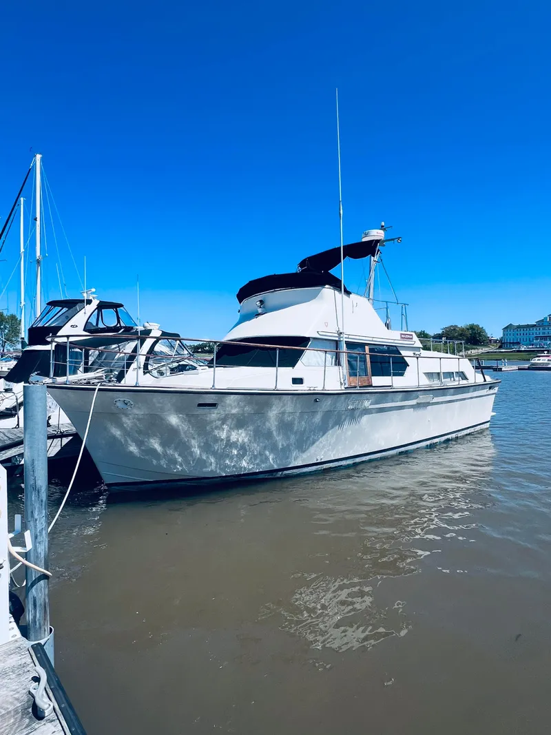 Slide: The Image of 1974 Tollycraft 40 Tri-Cabin Motoryacht docked in a marina under clear blue sky. - 2