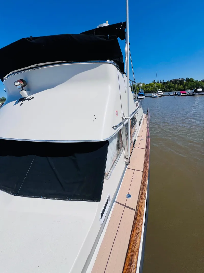 Slide: The Image of 1974 Tollycraft 40 Tri-Cabin Motoryacht docked on a sunny day. - 4
