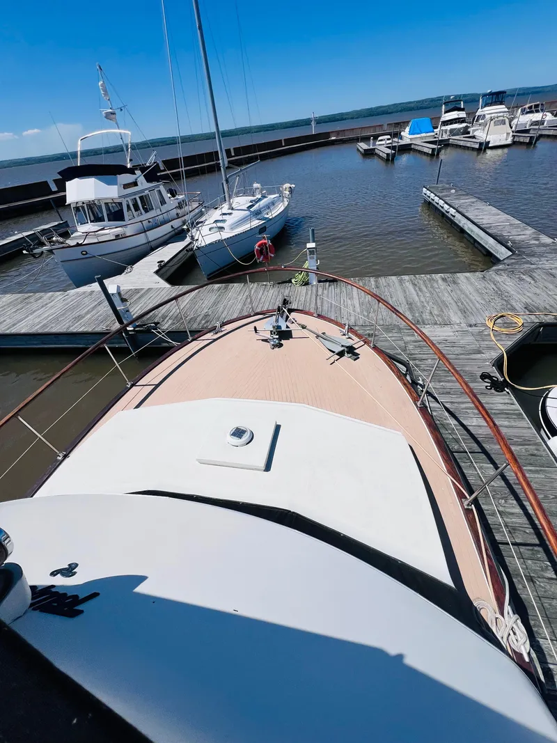 Slide: The Image of 1974 Tollycraft 40 Tri-Cabin Motoryacht docked at a marina under clear blue skies. - 6