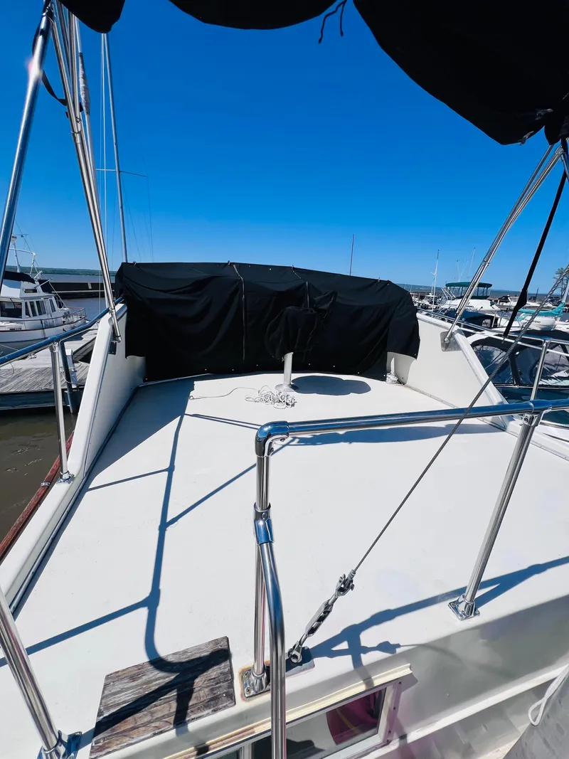 Slide: The Image of 1974 Tollycraft 40 Tri-Cabin Motoryacht deck view at marina under clear blue sky. - 7