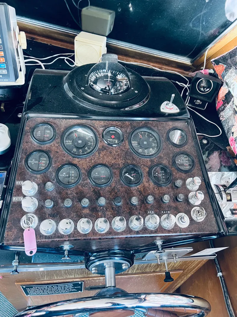 Slide: The Image of 1974 Tollycraft 40 Tri-Cabin Motoryacht dashboard with gauges and controls. - 9