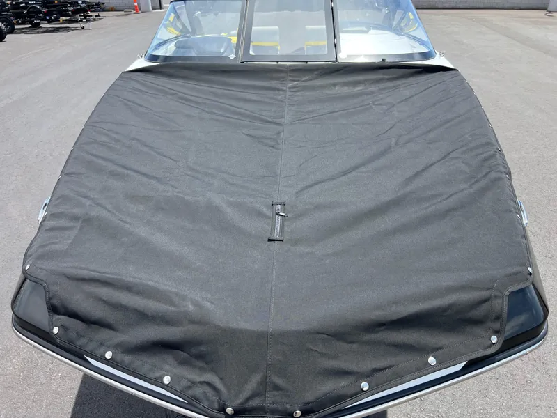 Slide: The Image of 2023 Scarab 255 Wake ID boat with black cover on a sunny day. - 19