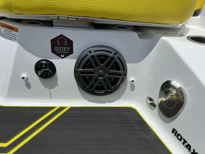 Slide: The Image of 2023 Scarab 255 Wake ID boat interior with speaker and yellow seating. - 20