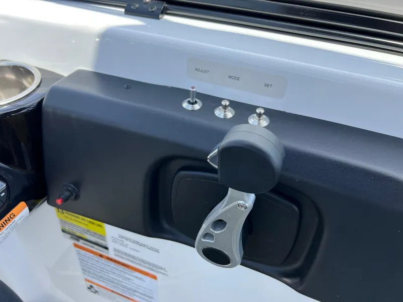 Slide: The Image of Control panel of 2023 Scarab 255 Wake ID boat with switches and throttle lever. - 22