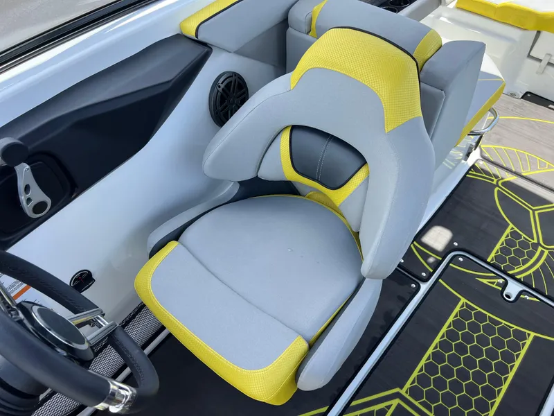 Slide: The Image of 2023 Scarab 255 Wake ID boat interior with gray and yellow seating. - 24