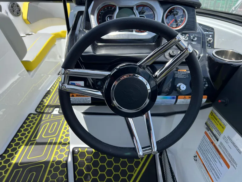 Slide: The Image of 2023 Scarab 255 Wake ID boat steering wheel and dashboard, featuring modern controls and design. - 25