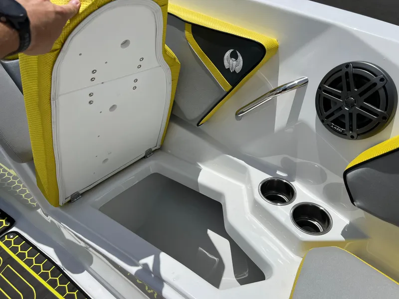 Slide: The Image of 2023 Scarab 255 Wake ID boat interior with storage, cup holders, and speaker. - 26