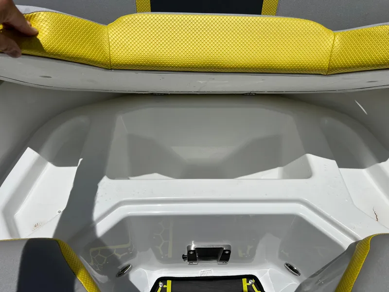 Slide: The Image of 2023 Scarab 255 Wake ID boat interior with yellow seating and storage compartment. - 28
