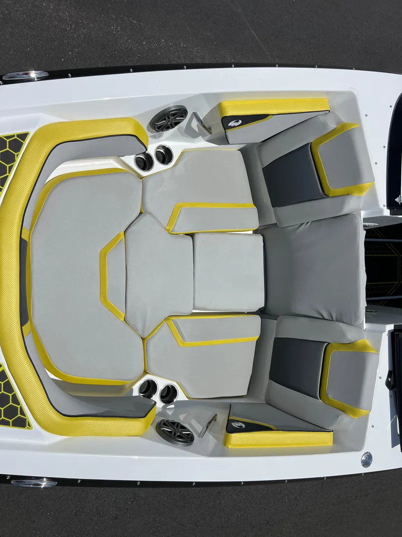 Slide: The Image of 2023 Scarab 255 Wake ID boat interior with gray and yellow seating. - 33