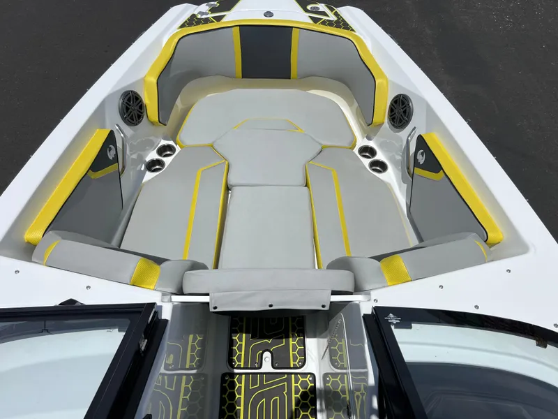 Slide: The Image of 2023 Scarab 255 Wake ID boat interior with gray and yellow seating, cup holders, and speakers. - 34