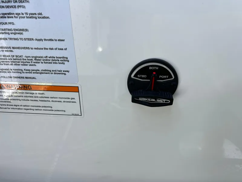 Slide: The Image of 2023 Scarab 255 Wake ID control panel with safety instructions and switch. - 38