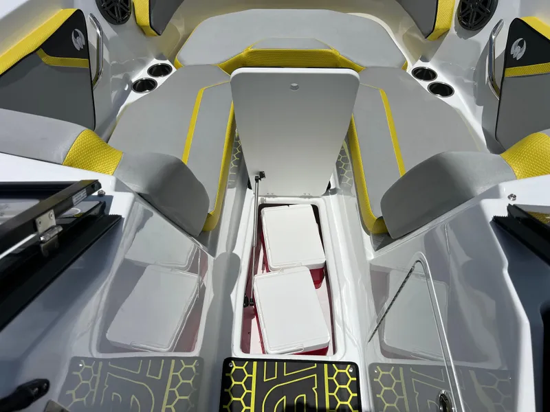 Slide: The Image of 2023 Scarab 255 Wake ID boat interior with yellow accents and storage compartments. - 44