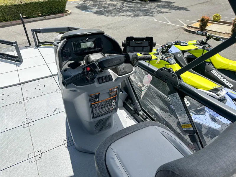 Slide: The Image of 2024 Sea-Doo Switch Sport 21 dashboard and controls, parked outdoors. - 10