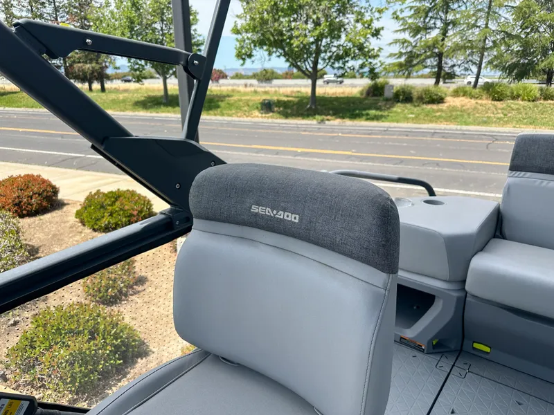 Slide: The Image of 2024 Sea-Doo Switch Sport 21 interior with gray seating and outdoor view. - 11