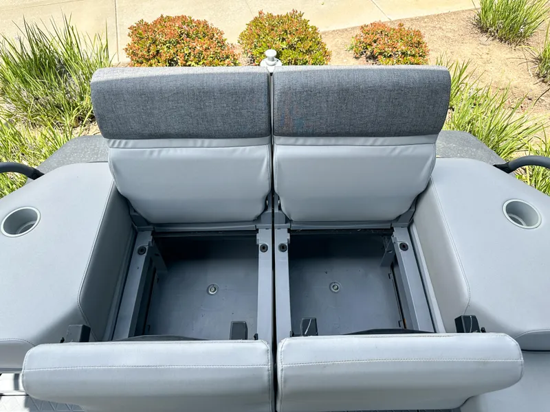 Slide: The Image of 2024 Sea-Doo Switch Sport 21 seating with storage compartments, gray upholstery, and cup holders. - 12