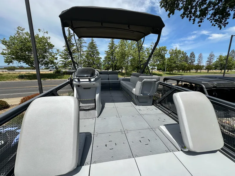 Slide: The Image of 2024 Sea-Doo Switch Sport 21 pontoon boat with spacious deck and canopy. - 8